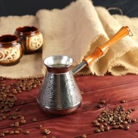 Турка для кофе медная "Орнамент", 0,5 л: Цвет: Приготовление кофе в турке или джезве — это древний обычай, который сохранился до наших дней неспроста.  Кофе, сваренный вручную, это уникальное удовольствие и роскошный ритуал.Традиционной популярностью у современных кофеманов пользуются медные турки, исторически происходящие из восточных стран. Медь обладает равномерной теплопроводностью, что позволяет приготовить кофе, отличающийся изысканным ароматом. Cама турка имеет узкое горлышко, что также немаловажно для приготовления кофе. Данная турка имеет специальное внутреннее покрытие из пищевого олова, которое предохраняет медь от окисления.
: Россия
